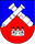 Ein Wappen zeigt gekreuzte Kanonenrohre über einer stilisierten Burg auf blau-rotem Hintergrund.