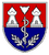 Ein Wappen zeigt zwei weiße Türme, einen Schlangenkaducäus und Lorbeerzweige auf einem rot-blauen Hintergrund.