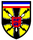 Ein Wappen mit zwei blauen Löwen auf rotem Schild, umgeben von gelben Blitzen und einer schwarz-weiß-blauen Flagge.