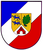 Ein Wappen zeigt zwei blaue Löwen, ein grünes Eichenblatt und ein rotes Tor auf einem goldenen Schild.
