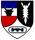 Ein Wappen zeigt einen Stierkopf, ein gezacktes Emblem und ein stilisiertes Brückensymbol auf farbigen Feldern.