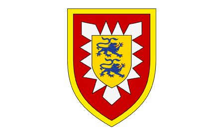 Ein Wappen zeigt zwei blaue Löwen auf gelbem Schild, umgeben von roten und weißen Zacken.