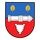 Ein Wappen zeigt eine Kanone auf blau-rotem Hintergrund mit zwei goldenen Blättern und einem gezackten weißen Symbol.