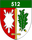 Ein Wappen zeigt eine weiße Schneeflocke, ein gelbes Schwert und ein grünes Eichenblatt mit der Zahl 512 oben.