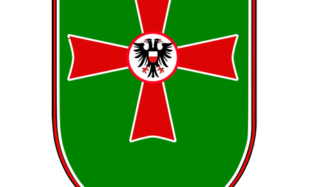 Ein grünes Wappen mit einem roten Kreuz und einem schwarzen Adler in der Mitte repräsentiert das Panzergrenadierbataillon 172.