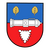 Ein Wappen zeigt eine Kanone auf blau-rotem Hintergrund mit zwei goldenen Blättern und einem gezackten weißen Symbol.
