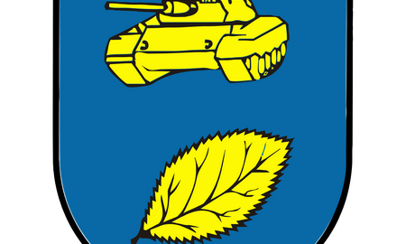 Ein Wappen zeigt einen gelben Panzer und ein gelbes Blatt auf blauem Hintergrund, symbolisch für Panzerbataillon 183.