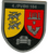 Wappen der 4. Panzerbataillon 184 mit Löwen, Adler und Panzer in gelb-rotem Schild.